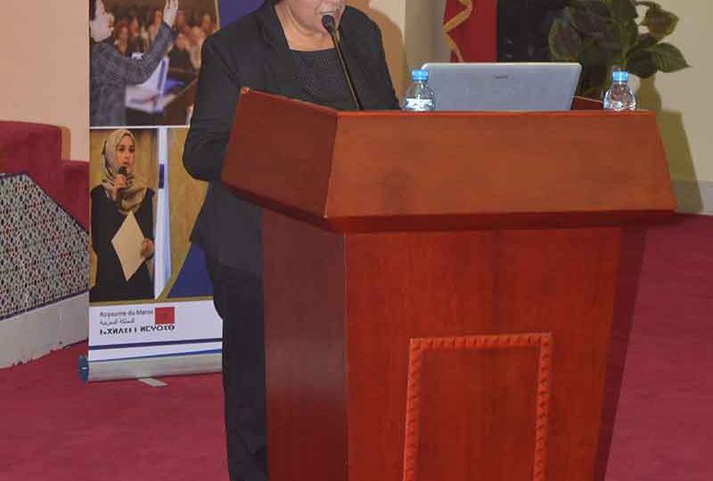 Woman speaks at podium in MENA region
