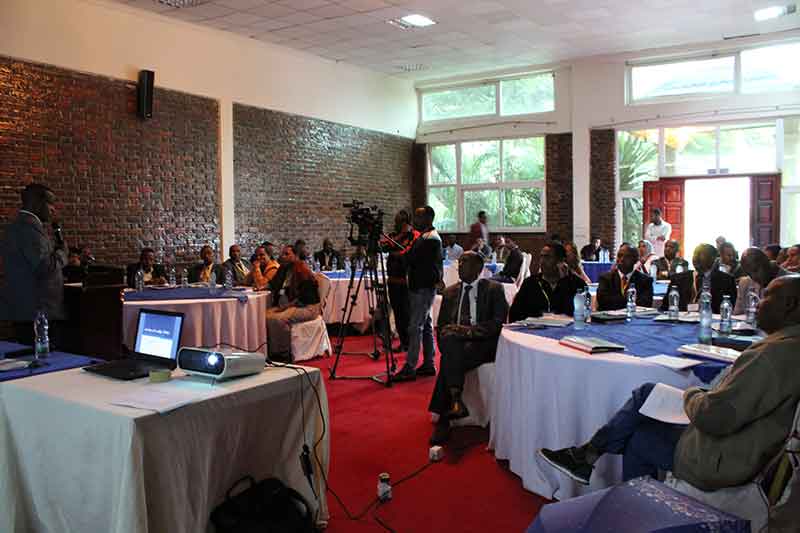 Man speaks at podium during a workshop in Ethiopia